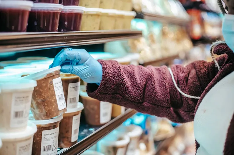 Image showing Winning with Private Labels service. Quality control personnel checking food label with blue gloves on